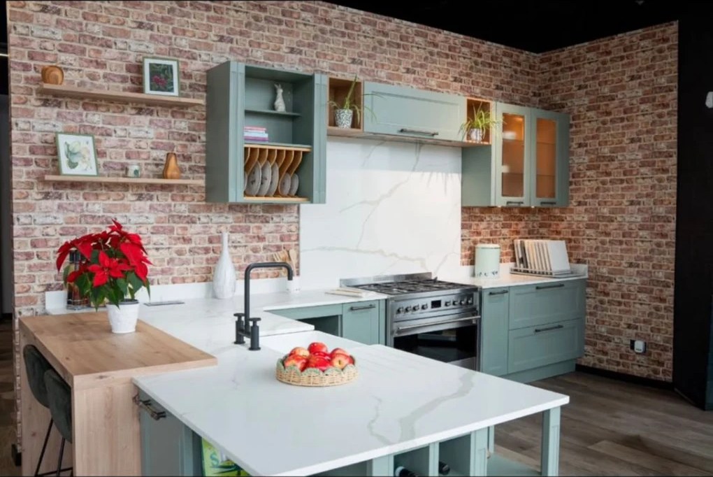 Sage green shaker kitchen with quartz worktops in the Kutchenhaus Irthlingborough showroom